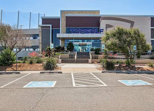 A parking lot in front of a Toggolf store.