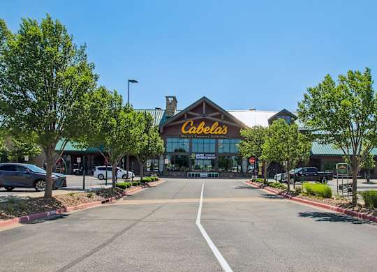 A view of a parking lot with a Celestis building in the background.
