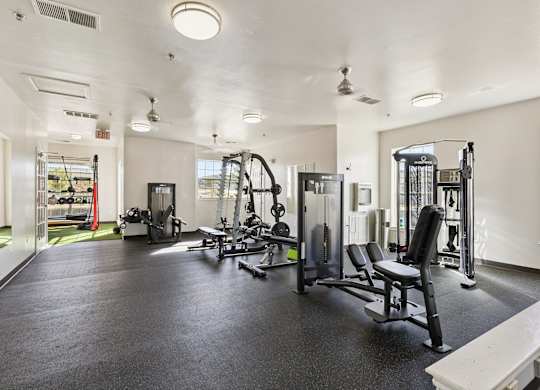 A spacious gym with various exercise equipment.