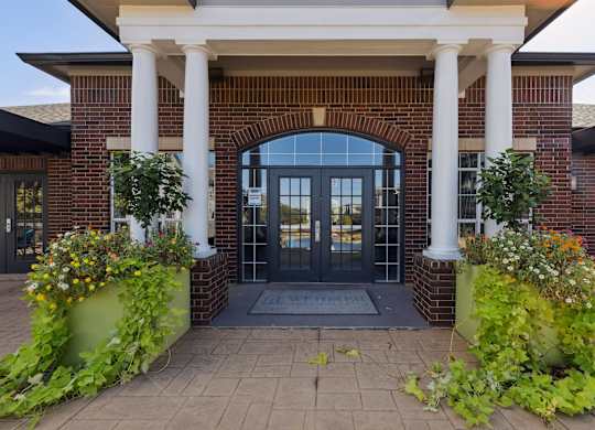 A building with a black door and white pillars.