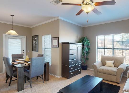 A living room with a dining table and chairs.