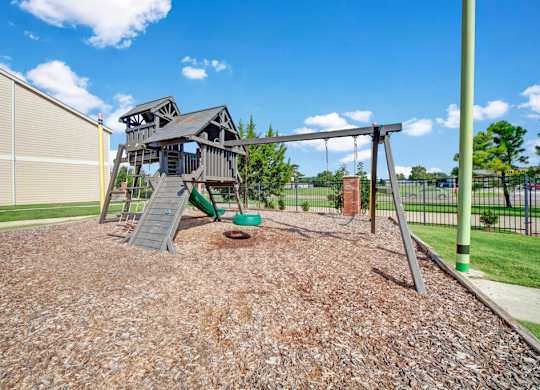 A playground with a swing set and a slide.