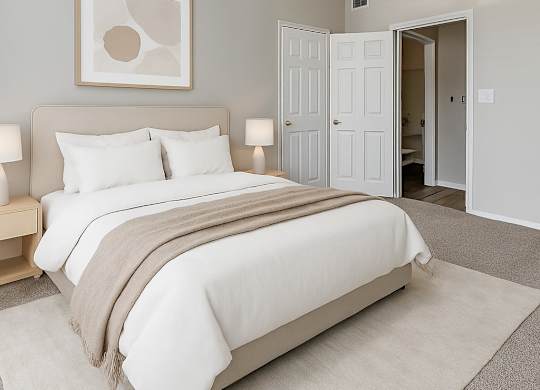 A bedroom with a large bed and a ceiling fan.
