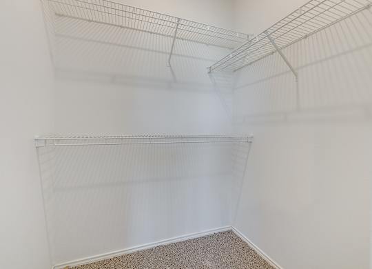 Empty white shelves in a room.