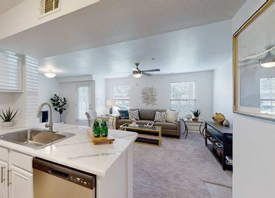 A modern kitchen with white cabinets and a large island.