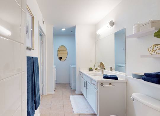 A bathroom with a white tub, sink, and toiletries.
