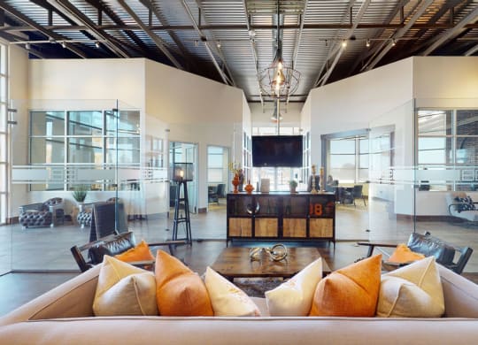 a large living room with a couch and chairs