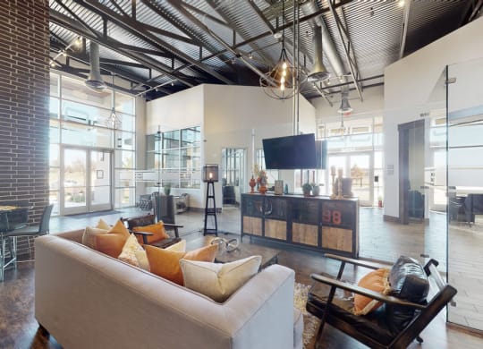 a living room with a couch chairs and a tv
