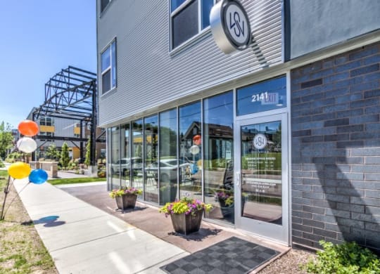 Stitchweld Apartments features a modern building exterior with large glass windows that reflect another building.