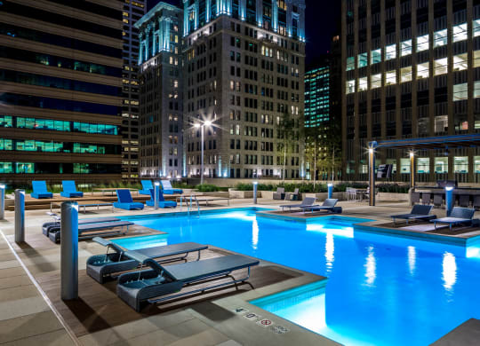 Nic on 5th Apartments in Minneapolis, Minnesota- Exterior night view of pool and recreational area
