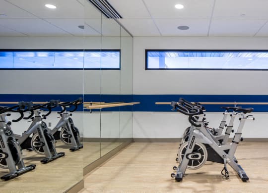 Nic on 5th Apartments in Minneapolis, Minnesota- Cycling bikes in fitness room with full lengths mirrors