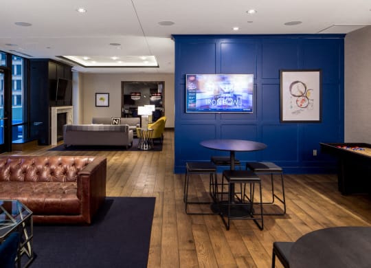 Nic on 5th Apartments in Minneapolis, Minnesota- Large common room with fireplace and floor to ceiling windows