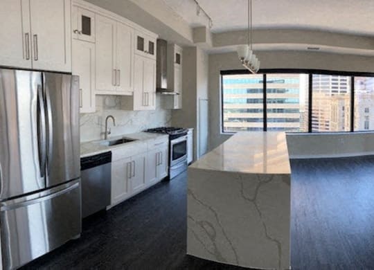 Nic on 5th Apartments in Minneapolis, Minnesota- large common area with luxury lighting design and wooden floors