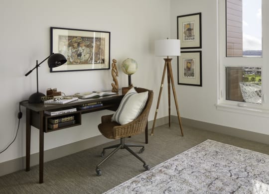 a home office with a desk and a window
