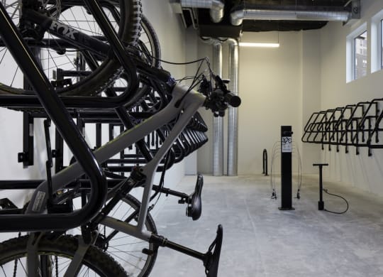 a group of bikes are hanging on a wall in a room