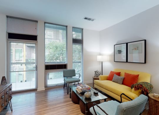 a living room with a yellow couch and two chairs