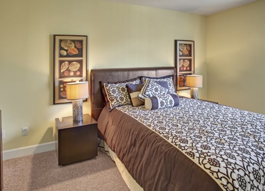 a bedroom with a large bed and two night stands with lamps