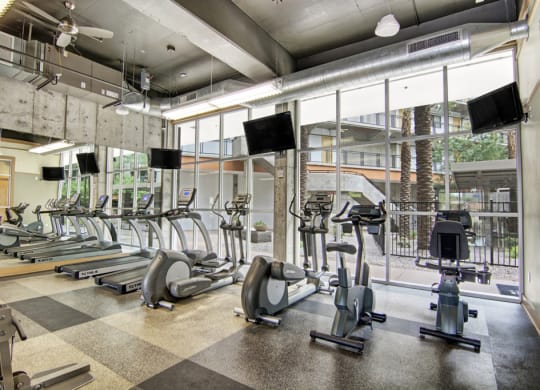 an image of a gym with treadmills and other exercise equipment