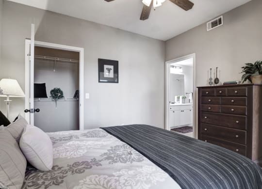 a bedroom with a large bed and a dresser