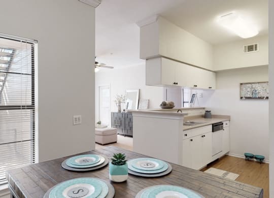 a kitchen and dining room with a table and chairs