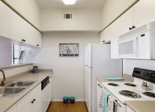 a kitchen with white cabinets and white appliances