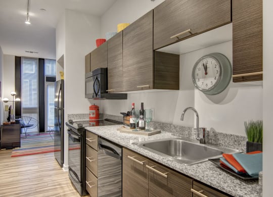 a kitchen with wood cabinets and granite countertops