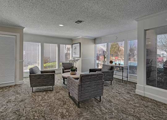 A living room with a grey carpet and furniture.