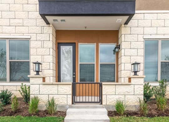 a house with a wooden door and a stone facade
