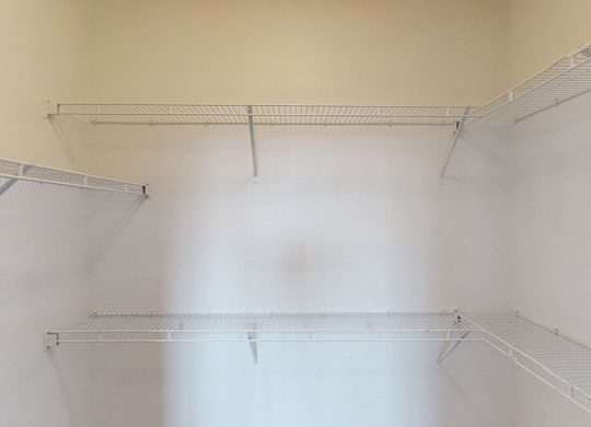 Empty shelves in a room with white walls.