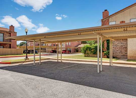 A parking lot with a canopy and numbered parking spaces.