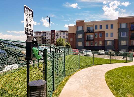 A sign on a fence indicates that it is a pet waste zone.