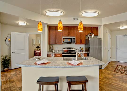 A kitchen with a bar stool in front of the island.
