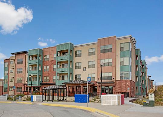 A large multi-story building with a parking lot in front.