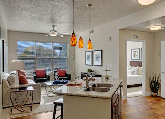 A kitchen with a white counter top and a sink.