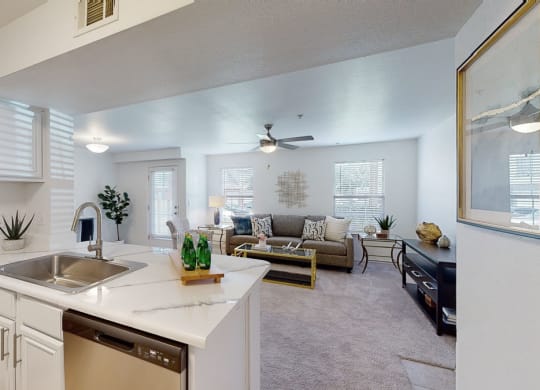 a kitchen and living room with a couch and coffee table