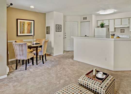 A kitchen and dining area with a table and chairs.