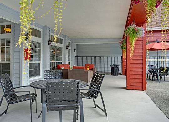 A patio with a table and chairs.
