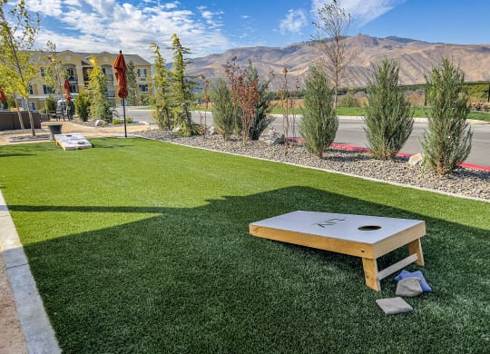 a patio with a ping pong table and a view of the mountains