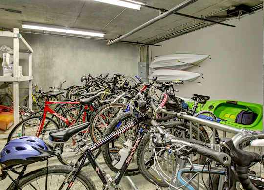 A bike helmet is on a bike in a parking garage.