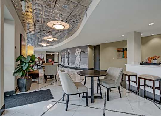 A modern dining room with a round table and chairs.