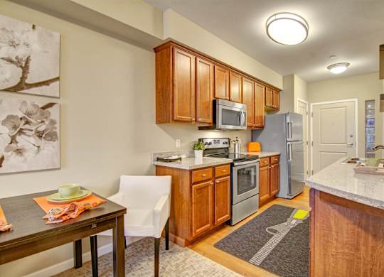 A kitchen with wooden cabinets and a white counter.