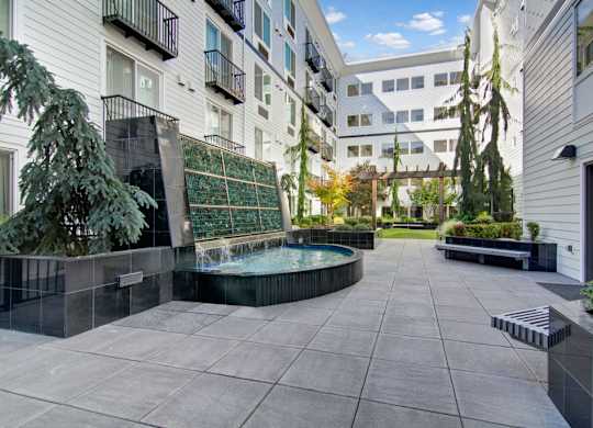 A courtyard with a pool surrounded by buildings.