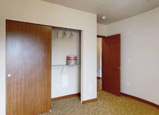 a bedroom with a closet and a door to a bathroom