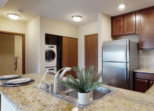 a kitchen with a sink and a refrigerator