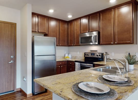 a kitchen with a granite counter top and stainless steel appliances