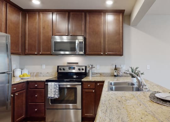 a kitchen with wooden cabinets and stainless steel appliances