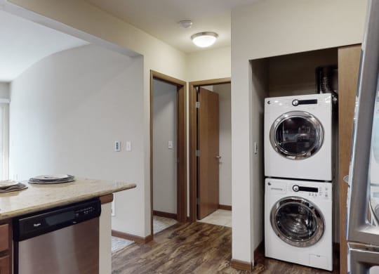 a kitchen with a washer and dryer and a sink
