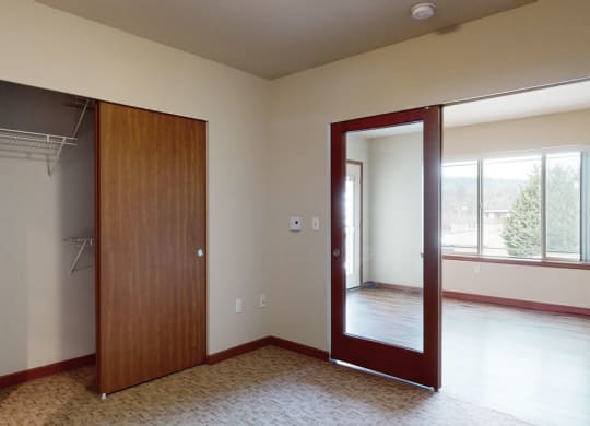 a bedroom with a closet and a window