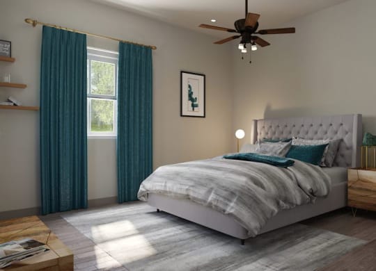 Cozy bedroom here at 49 West Apartments with a gray tufted bed, teal curtains, and wooden nightstands. A ceiling fan and sunlight create a calm, inviting atmosphere.
