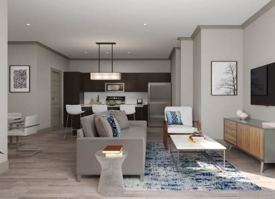 Modern open-plan living room here at 49 West Apartments and kitchen with neutral tones and wooden accents. A gray sofa, blue-patterned rug, and framed art create a cozy, stylish space.